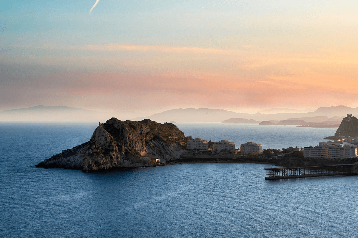 A bright, sunny mountain range at dawn representing potential and growth